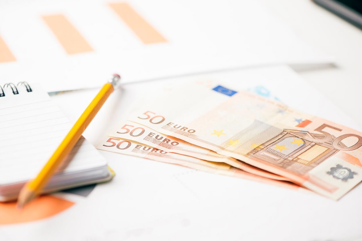 Crayon, billet en euros et bloc-notes